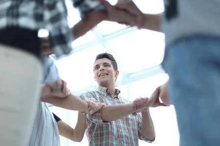 group of active youth forms a circle of handsの写真素材