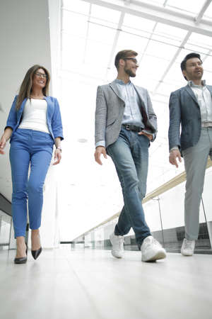 Business people walking in the office corridorの写真素材