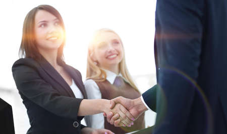 business colleagues shaking hands after a successful presentation.の写真素材