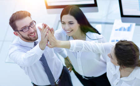 successful business team giving each other a high five .