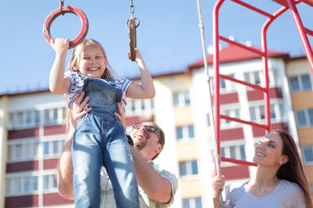 young family in the yard of a new houseの写真素材
