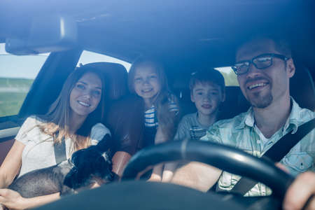 family with two children traveling in a family carの写真素材