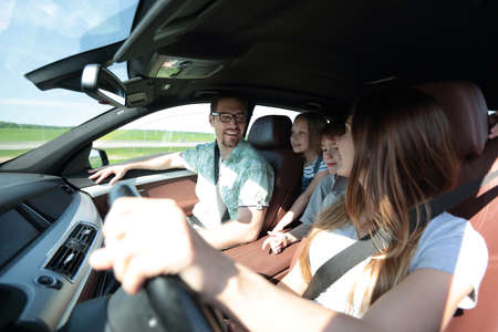 happy mom driving a family car