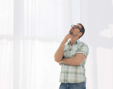 smiling man looks up at a copy of the spaceの写真素材