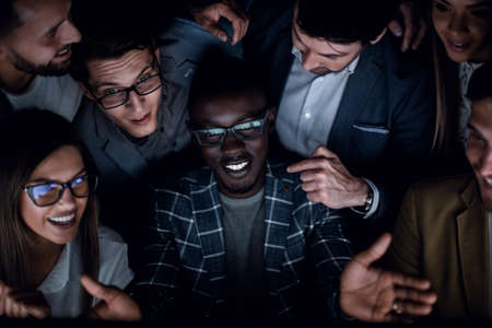 close up.a successful business team looks at the computer screen with passionの写真素材