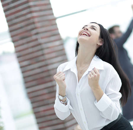 happy young business woman on a blurred office background.の写真素材