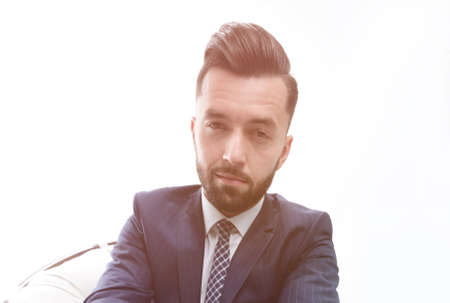 successful businessman sitting in a chair.