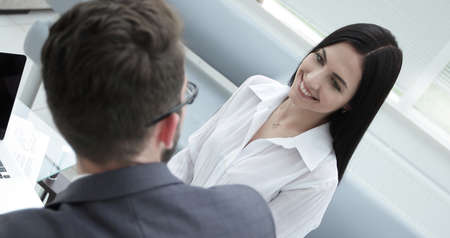 close-up of a young business woman talking with a colleague.