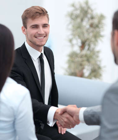 handshake business partners in the lobby of the office.の写真素材