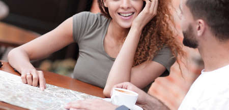 Portrait of a  happy couple sitting down at a cafe