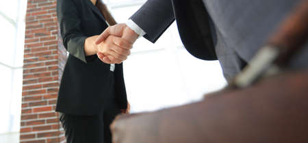 Close up of businessman and businesswoman shaking handsの写真素材