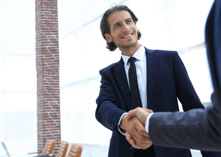 business group welcomes partner with a handshake