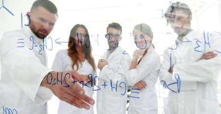 in the background image group laboratory scientists discussing their research