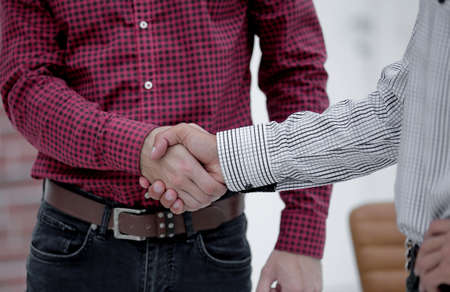 Closeup of a business hand shake between two colleagues