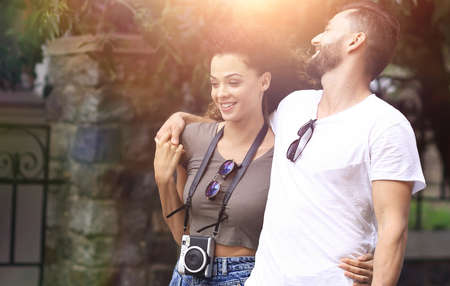 Cheerful young couple walking on urban streetの写真素材