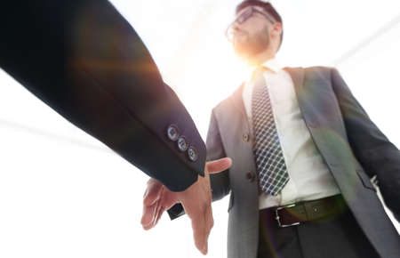 Two  business men going to make handshakeの写真素材