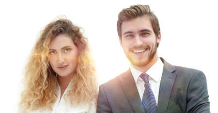 two young business people stand with arms folded