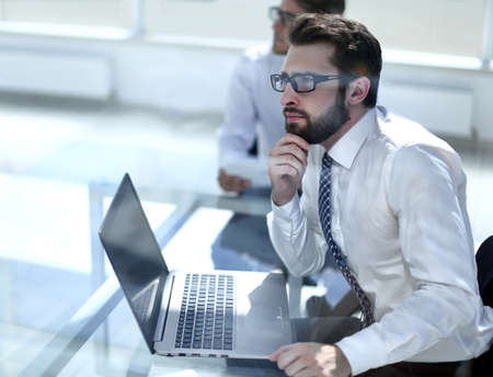 dreaming employee sitting at the office Desk.の写真素材