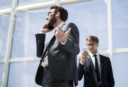 side view.business man talking on mobile phoneの写真素材