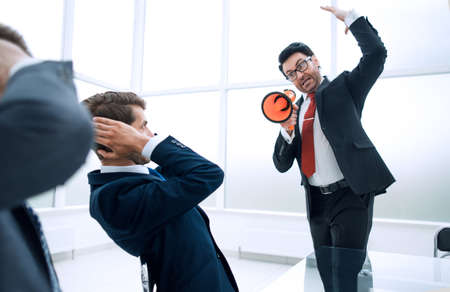 strict businessman scolds his subordinates at the meetingの写真素材