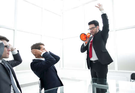 strict businessman with a megaphone in the conference roomの写真素材
