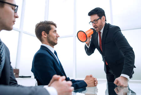 businessman with a megaphone in the conference room during the meetingの写真素材
