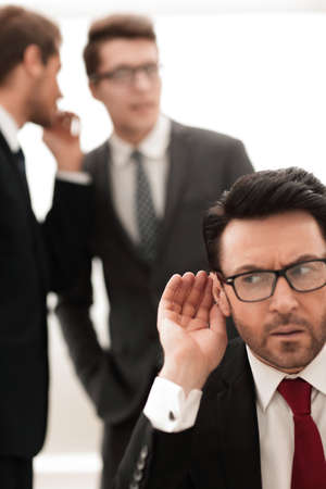 boss is trying to hear gossipの写真素材