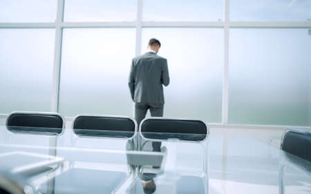 rear view of a stylish businessman looking out the window