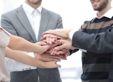 business colleagues with their hands stacked together