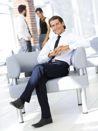 smiling businessman sitting in office chairの写真素材