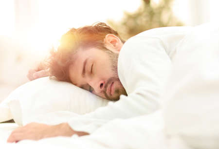 closeup.the tired men sleep soundly on the bed