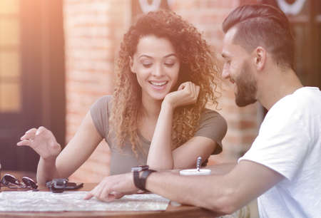 Portrait of a  happy couple sitting down at a cafe