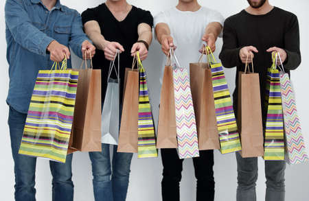 a group of people holds a gift bag.
