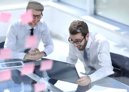 two happy employees reading a business documentの写真素材