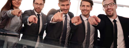 Businessmen in their office pointing to the frontの写真素材