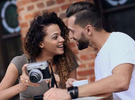 Portrait of a couple sitting down at a cafe and looking  photosの写真素材