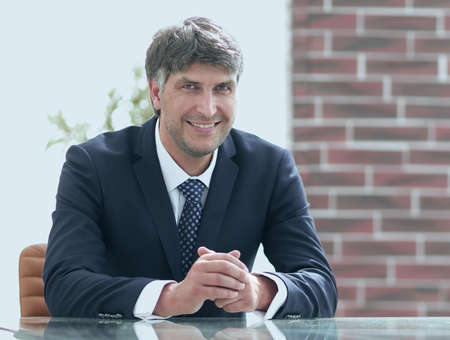 Serious businessman sitting at the desk