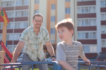 happy father playing with little boy on the Playgroundの写真素材