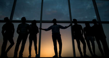 leader and the business team on background of office windowの写真素材