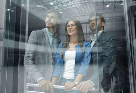 Business team group going on elevator.