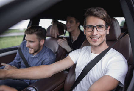 Close up side portrait of happy man driving car
