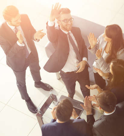 Happy successful business team giving a high fives gesture as th