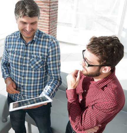 Two Men Using Tablet Computer In Creative Office Two Men Using Tablet Computer In Creative Office