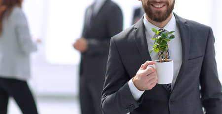 businessman with green young escape on blurred backgroundの写真素材