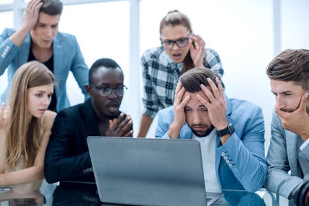 group of people looking at laptop
