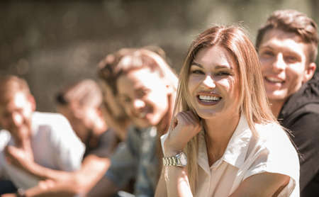 successful girl on the background of her friends in the Park.