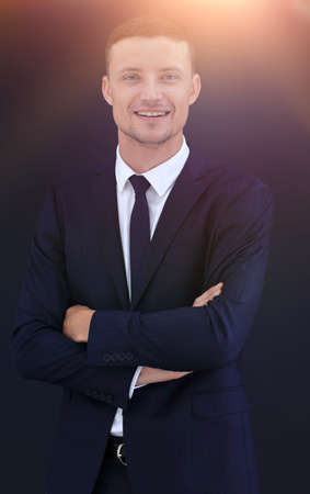 portrait of happy businessman isolated on a dark backgroundの写真素材