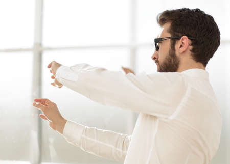 businessman looking through the glass wallの写真素材