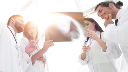 medical workers looking at patients x-ray film