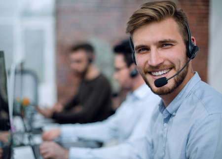 smiling business center staff sitting at the Desk